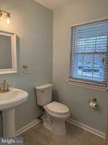 a white toilet sitting next to a bathroom sink