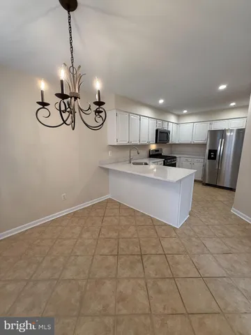 a kitchen with stainless steel appliances granite countertop a sink a stove top oven a counter space and cabinets