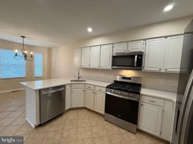 a kitchen with granite countertop a stove and a sink