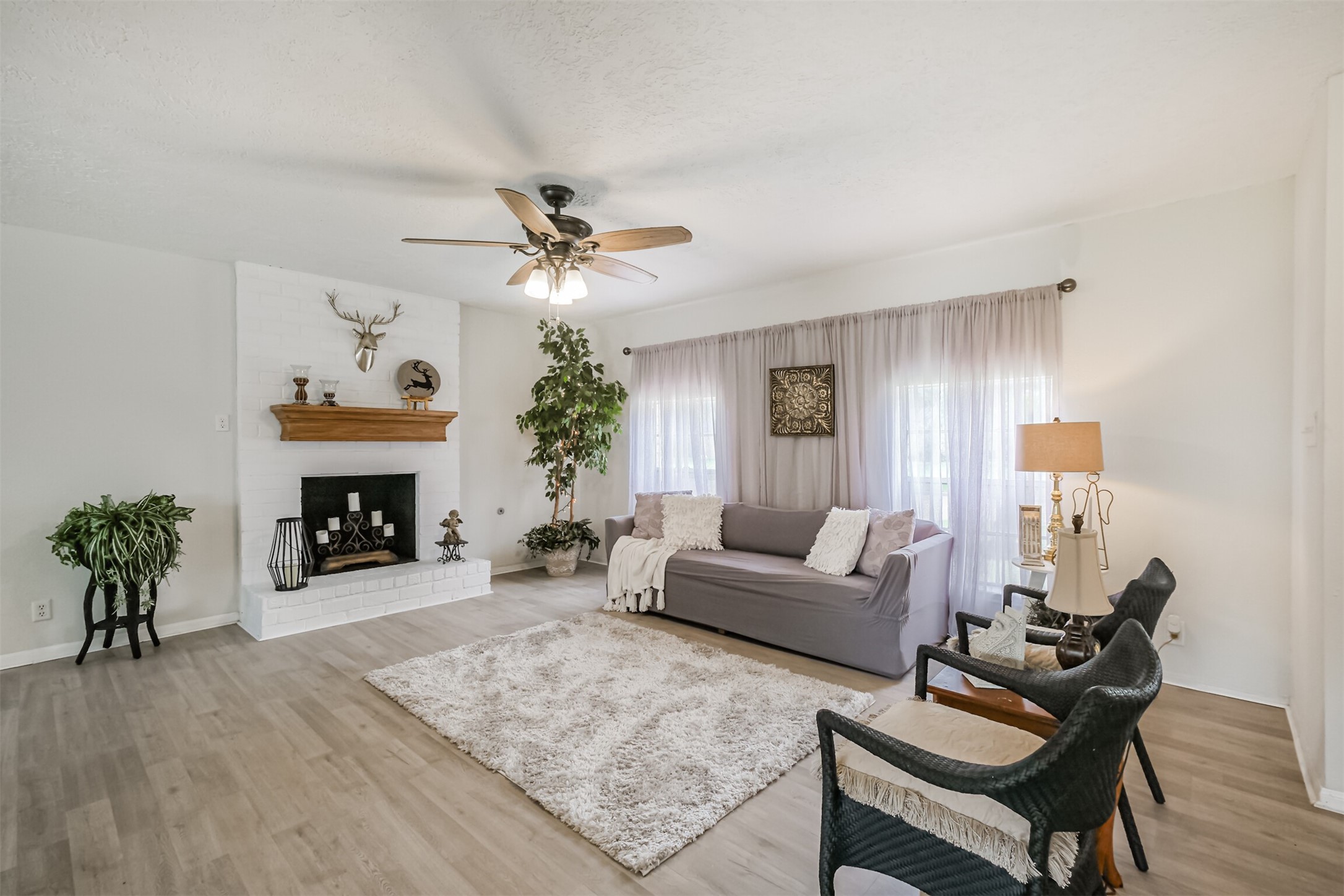 2705 Parrott Avenue Rosenberg, TX 77471 - Photo 5 of 37 a living room with furniture a fireplace and a potted plant