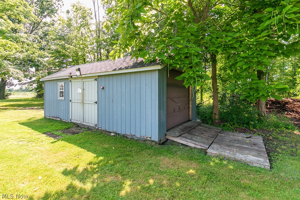 16506 Leroy Thompson Road Thompson, OH 44086 - Photo 13 of 41 View of outbuilding featuring a lawn