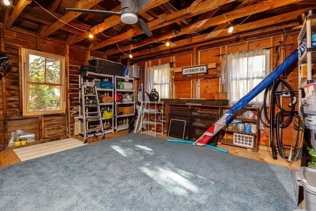 a view of an empty room with furniture and a staircase