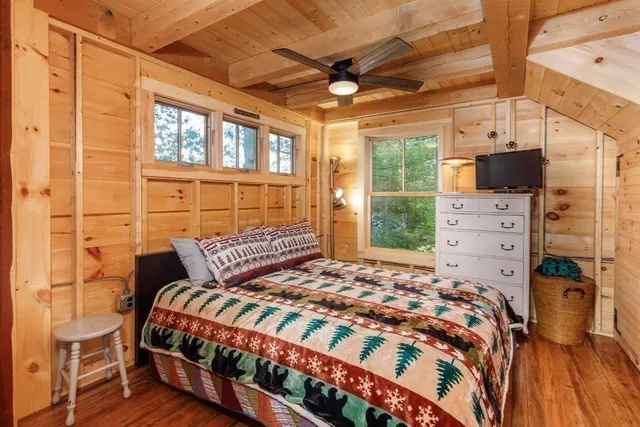 a bedroom with a bed dresser and a window