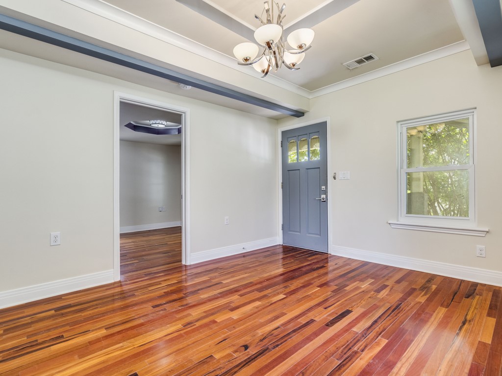 2314 Santa Rosa Street Austin, TX 78702 - Photo 5 of 27 Entryway with hardwood / wood-style floors, a chandelier, and crown molding