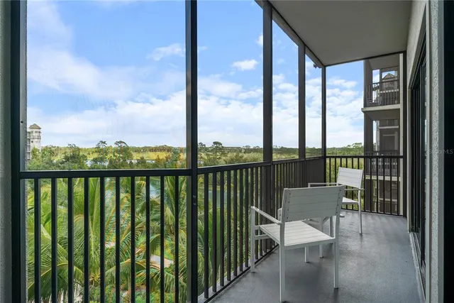 a view of a balcony with chairs