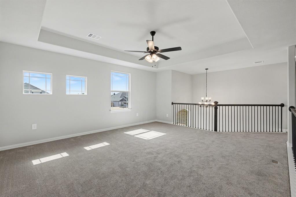 7041 Champion Road Midlothian, TX 76065 - Photo 18 of 30 a view of a livingroom with a ceiling fan and window