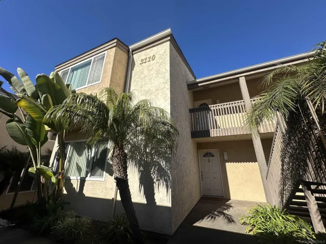 a view of a house with a tree