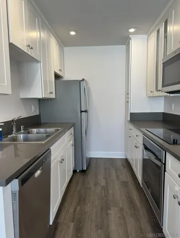 a kitchen with stainless steel appliances a sink stove and refrigerator