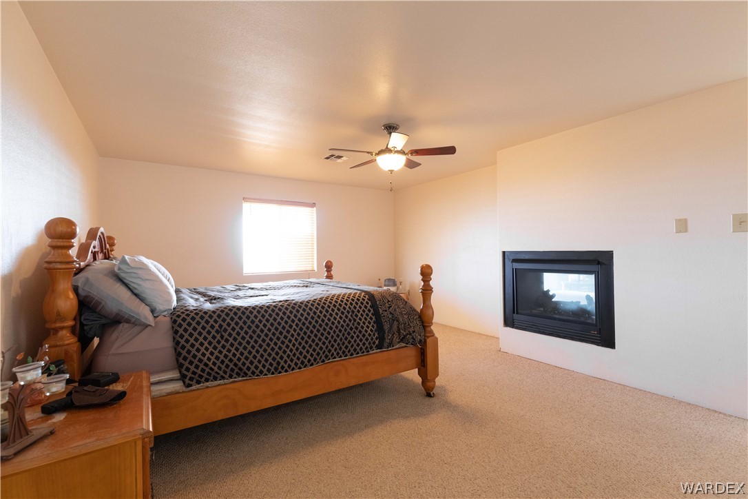 2136 Dewey Road Golden Valley, AZ 86413 - Photo 15 of 44 a bed room with a bed and a lamp