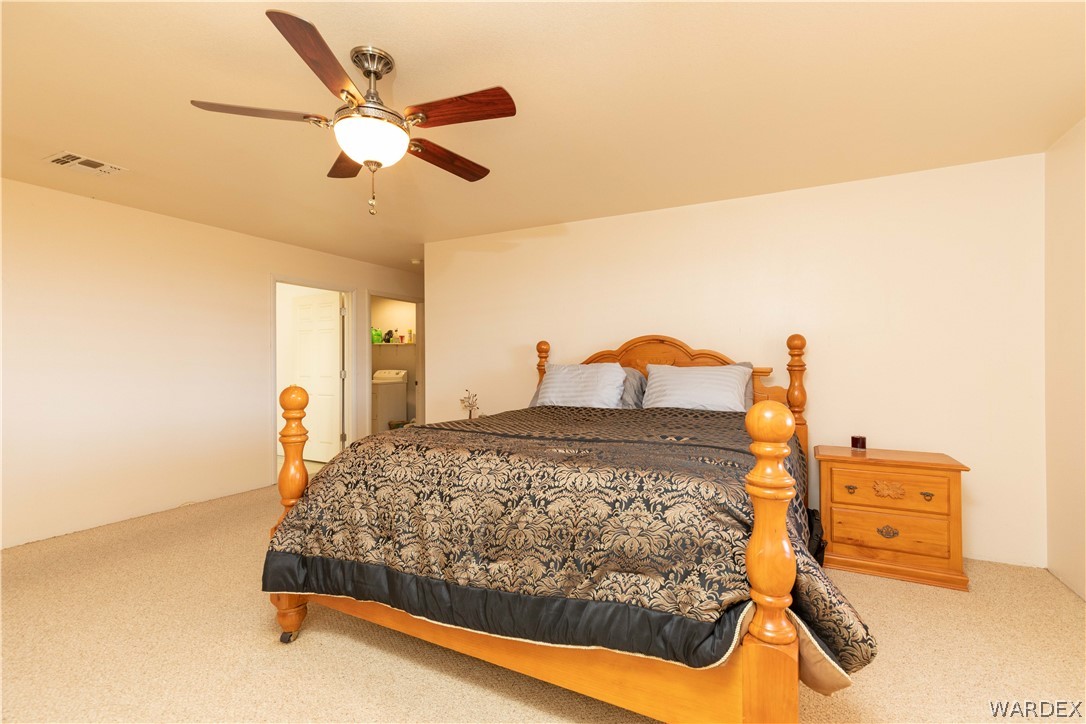 2136 Dewey Road Golden Valley, AZ 86413 - Photo 16 of 44 a bedroom with a bed and ceiling fan