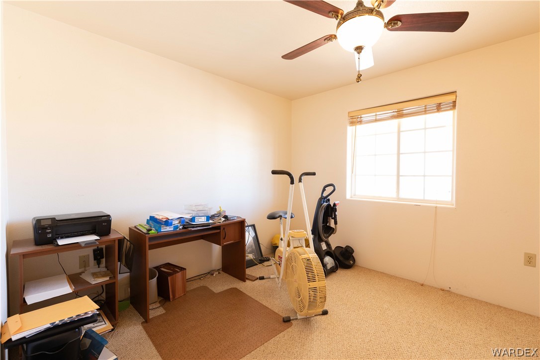 2136 Dewey Road Golden Valley, AZ 86413 - Photo 20 of 44 a view of a workspace with furniture and gym equipment