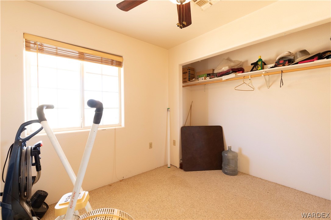 2136 Dewey Road Golden Valley, AZ 86413 - Photo 21 of 44 a view of walk in closet with empty racks
