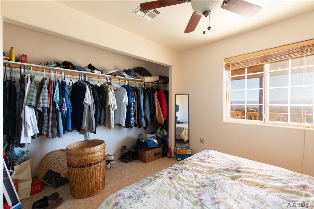 2136 Dewey Road Golden Valley, AZ 86413 - Photo 25 of 44 a view of walk in closet with clothes and shoes