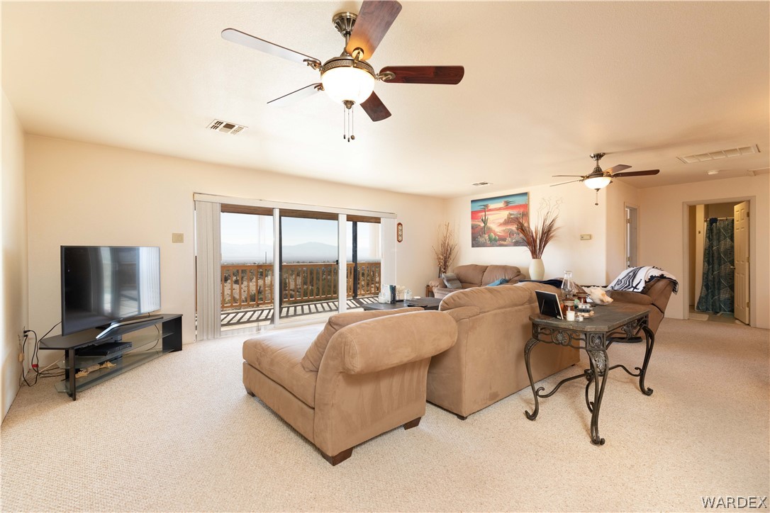 2136 Dewey Road Golden Valley, AZ 86413 - Photo 8 of 44 a living room with furniture and a flat screen tv