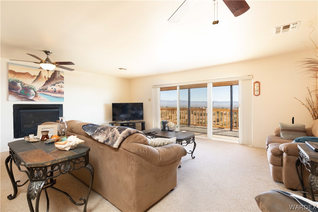 2136 Dewey Road Golden Valley, AZ 86413 - Photo 9 of 44 a living room with furniture and a flat screen tv