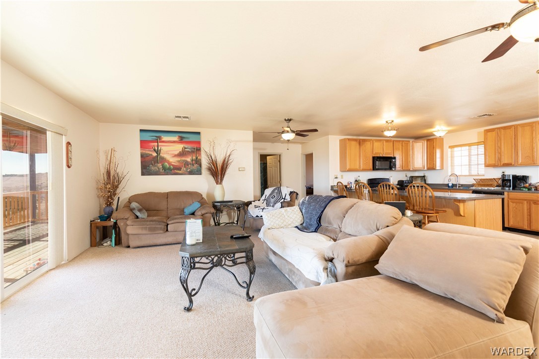 2136 Dewey Road Golden Valley, AZ 86413 - Photo 10 of 44 a living room with furniture and a flat screen tv