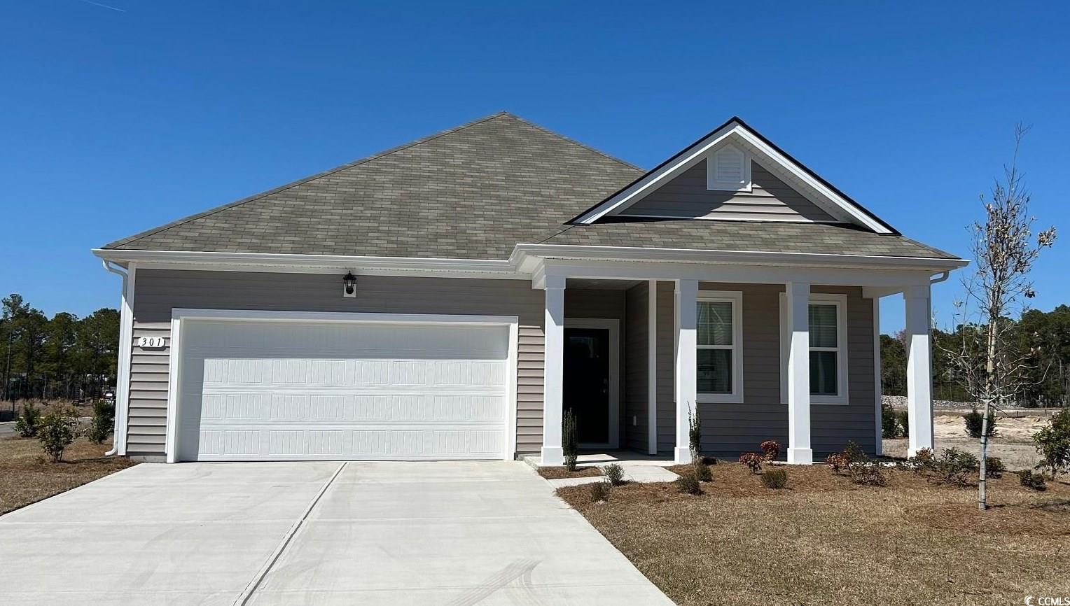 View of front of home featuring covered porch, dri