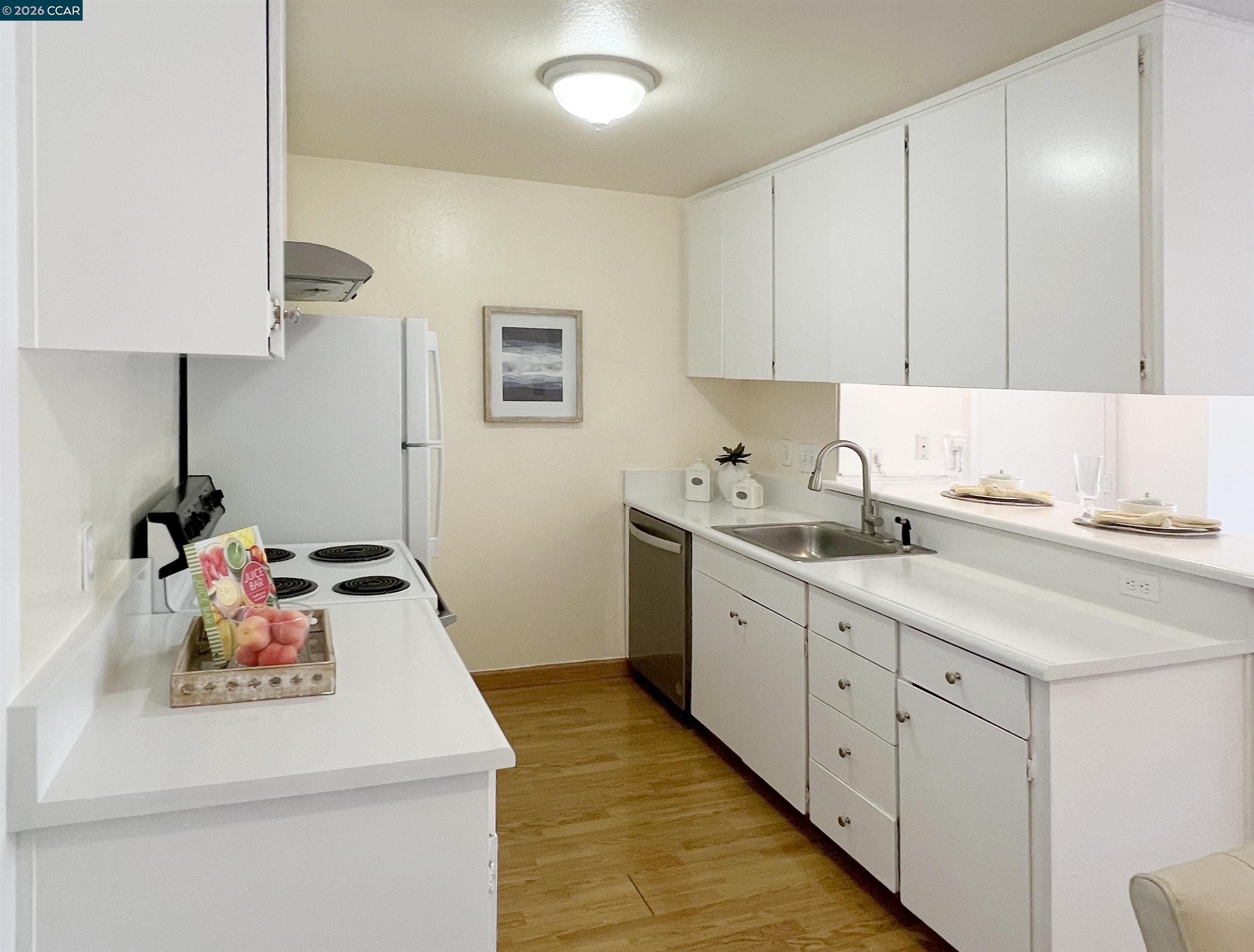 9085 Alcosta Boulevard, Unit 424 San Ramon, CA 94583 - Photo 11 of 21 a kitchen with a sink stove and cabinets