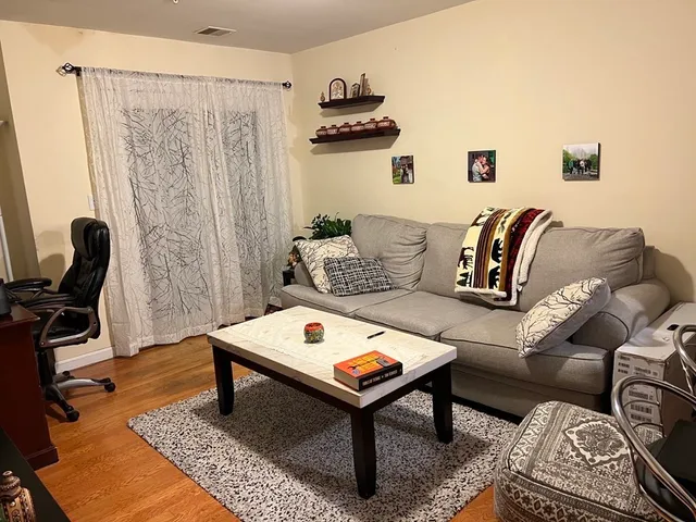 a living room with furniture and a rug