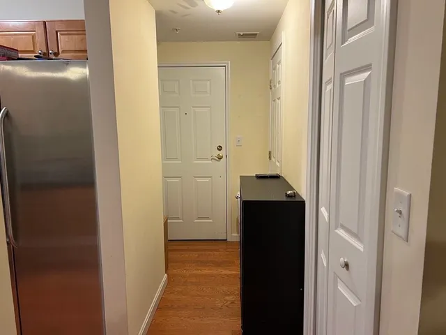 a view of a hallway with a wooden cabinets