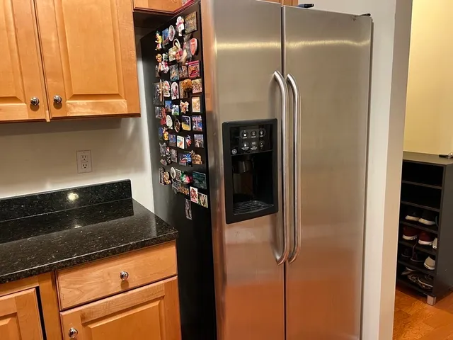 a kitchen with a refrigerator and cabinets