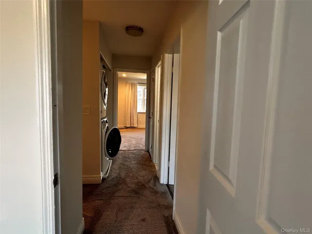 a view of a hallway with a wooden door