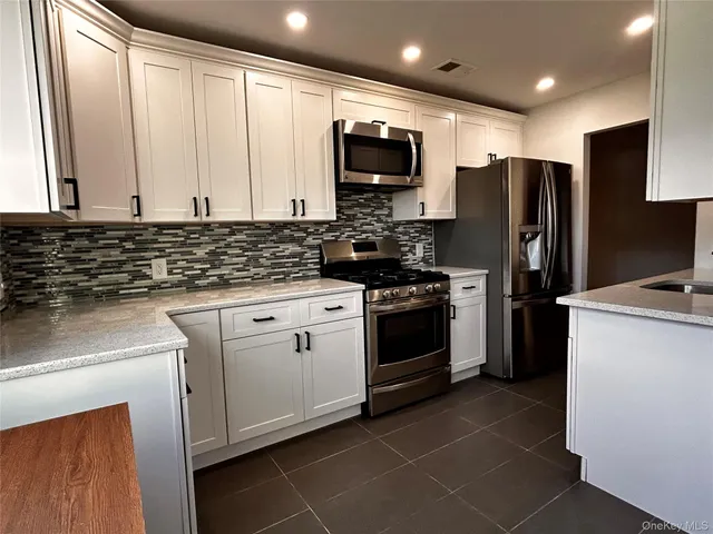 a kitchen with a sink a stove and refrigerator