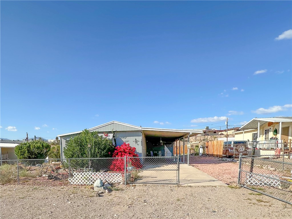 1655 Ramar Road Bullhead City, AZ 86442 - Photo 1 of 49 Manufactured Home with a fenced front yard, double gates, RV Parking and a carport