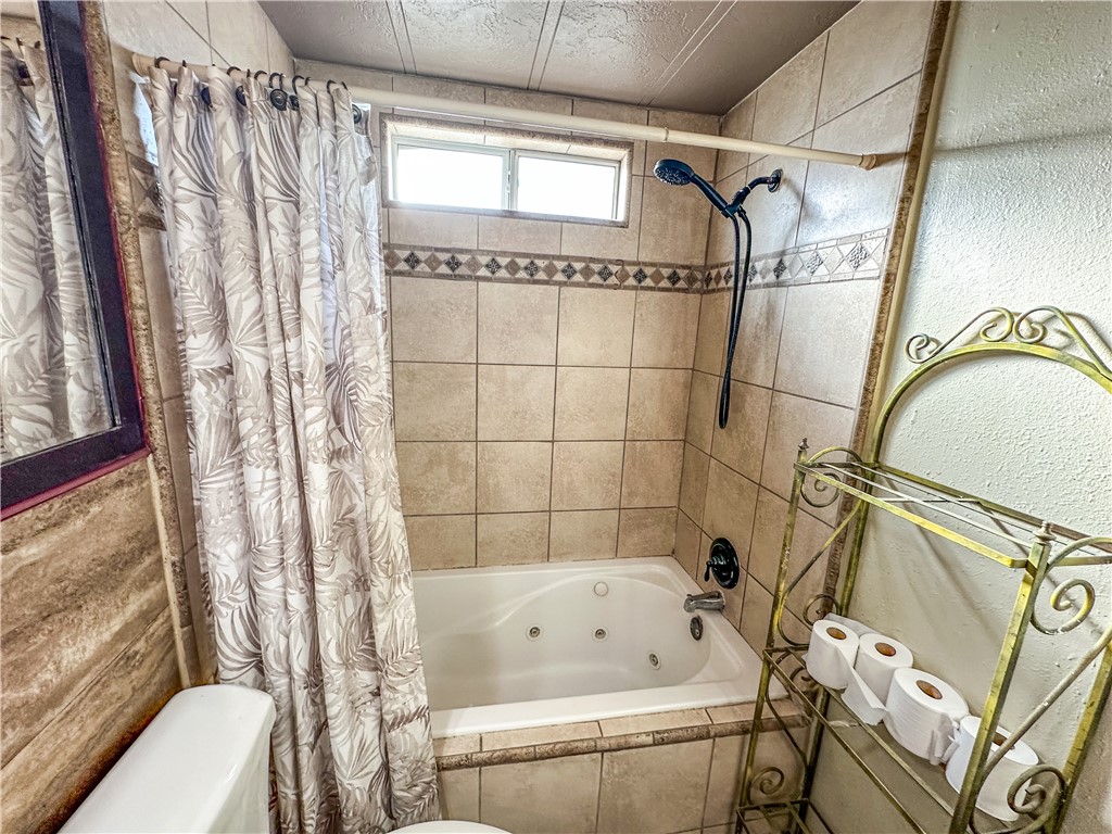 1655 Ramar Road Bullhead City, AZ 86442 - Photo 22 of 49 Full bath with a combined bath / shower with jetted tub and a textured wall