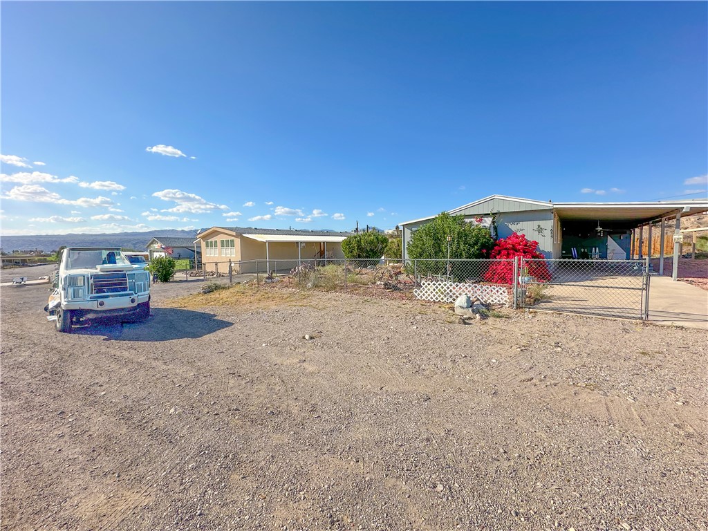 1655 Ramar Road Bullhead City, AZ 86442 - Photo 42 of 49 Fenced front yard with a gate