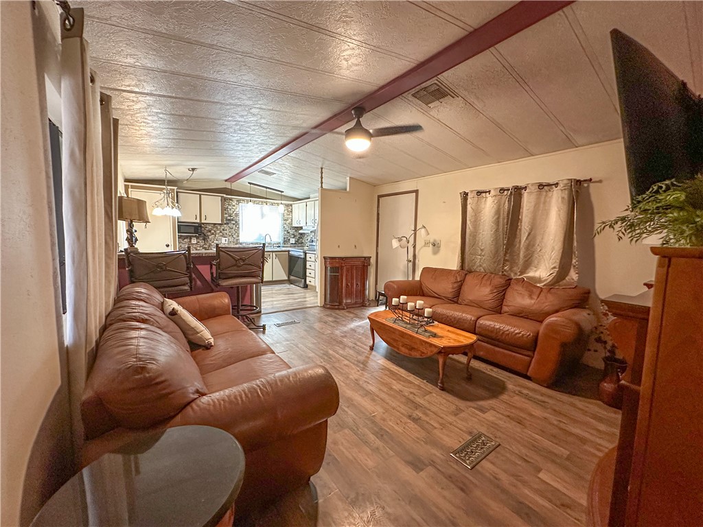 1655 Ramar Road Bullhead City, AZ 86442 - Photo 5 of 49 Living area featuring wood finished floors and beamed ceiling
