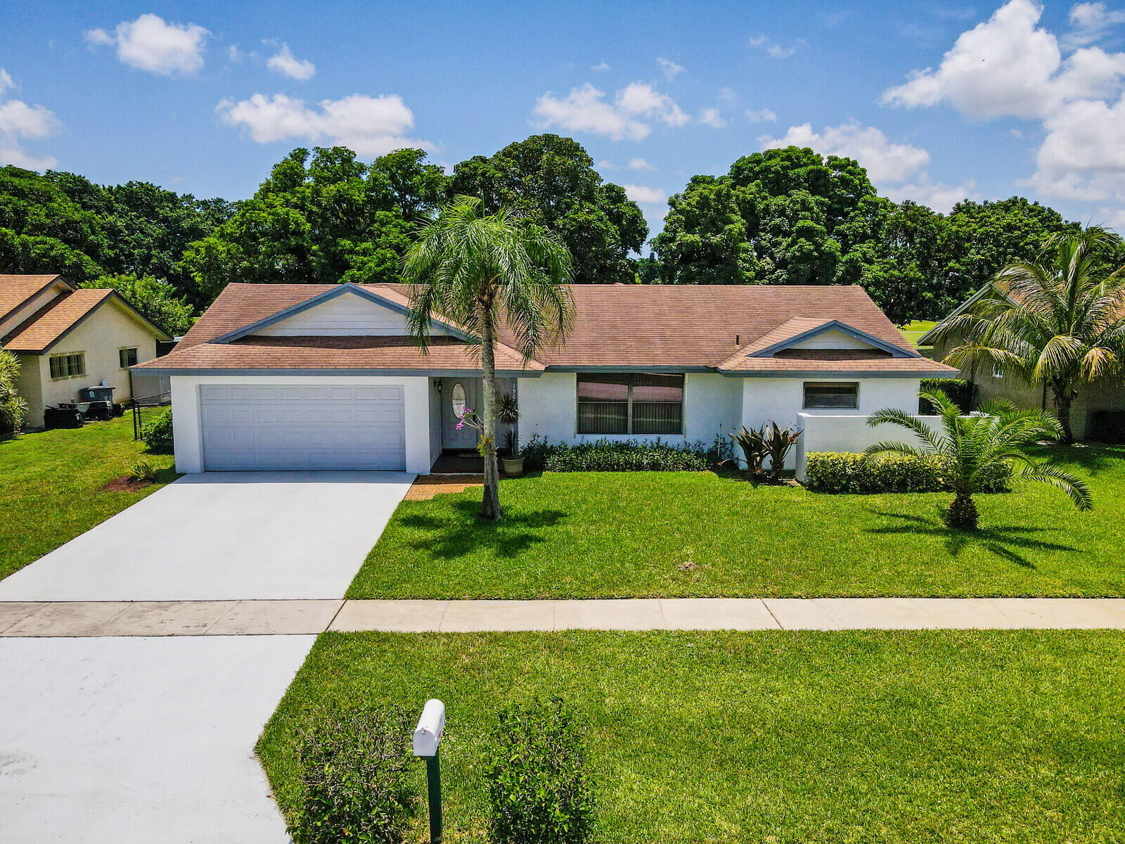 19620 Hampton Drive Boca Raton, FL 33434 - Photo 1 of 45 a front view of house with yard and green space