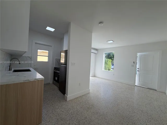 a view of a kitchen cabinets and a livingroom