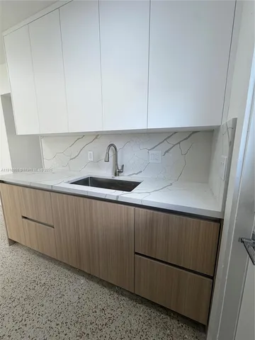 a kitchen with a sink and cabinets