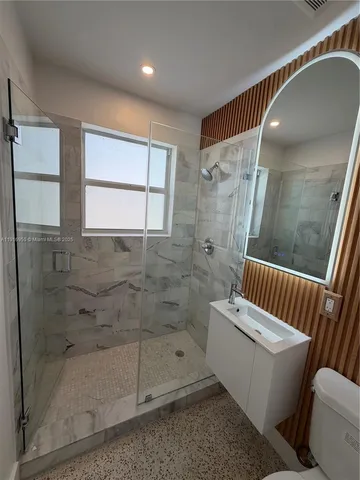 a bathroom with a bathtub and shower