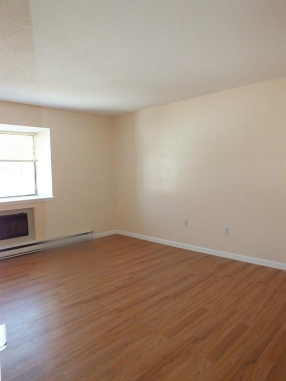 93 Kent Court, Unit 93 Meriden, CT 06450 - Photo 11 of 27 an empty room with wooden floor and windows
