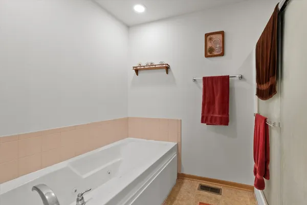 a bathroom with a bath tub and a shower