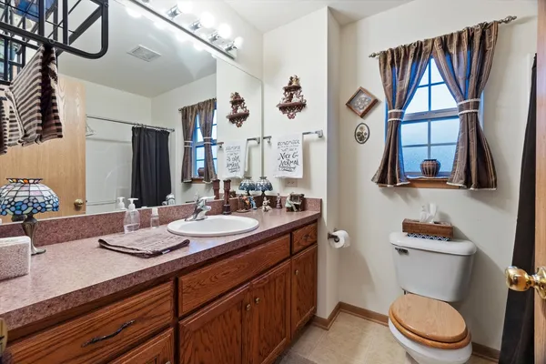 a bathroom with a sink a toilet and a mirror