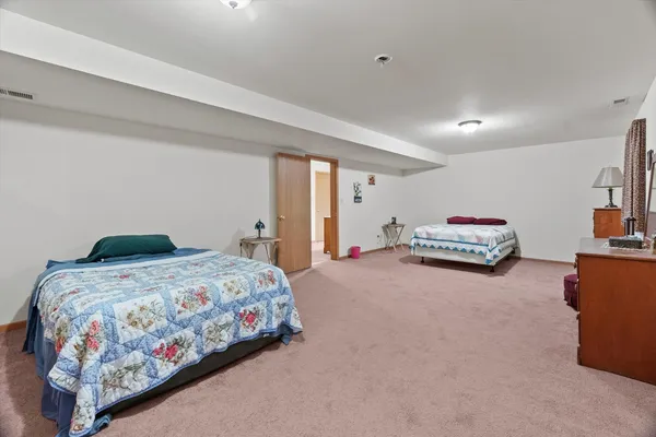 a bedroom with a bed and a dresser