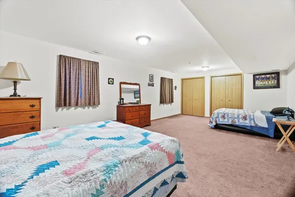 a bedroom with a bed and a couch