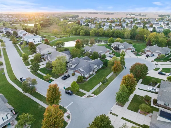 an aerial view of multiple houses with yard