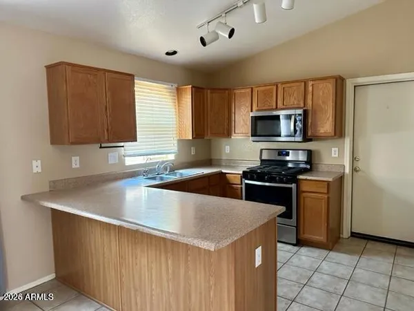 a kitchen with stainless steel appliances a refrigerator and a stove top oven