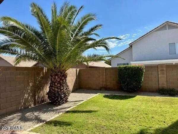 a view of a house with backyard and porch