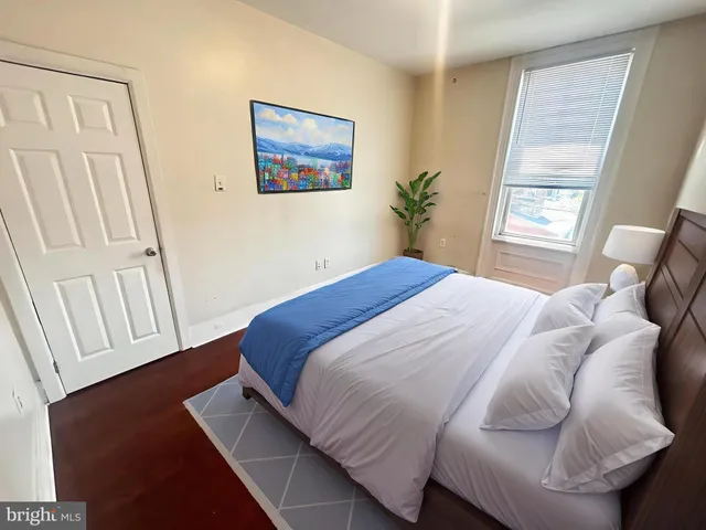 a bedroom with a bed and a window