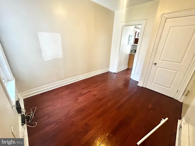 an empty room with wooden floor