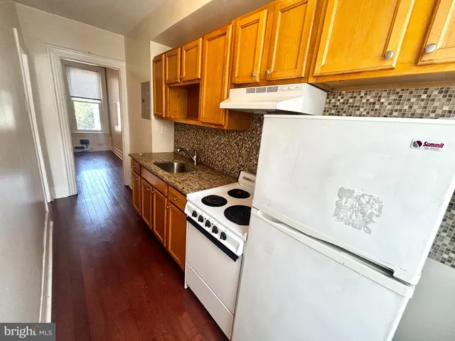 a kitchen with stainless steel appliances a stove a microwave and a refrigerator