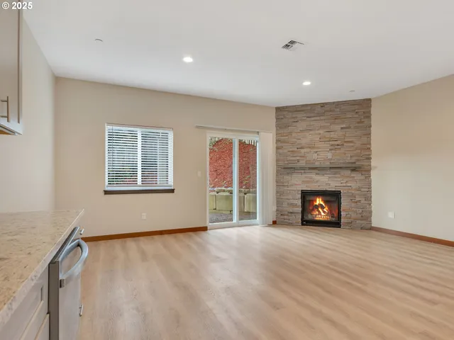 wooden floor in an empty room with a fireplace