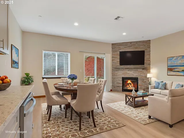 a living room with furniture a fireplace and a flat screen tv