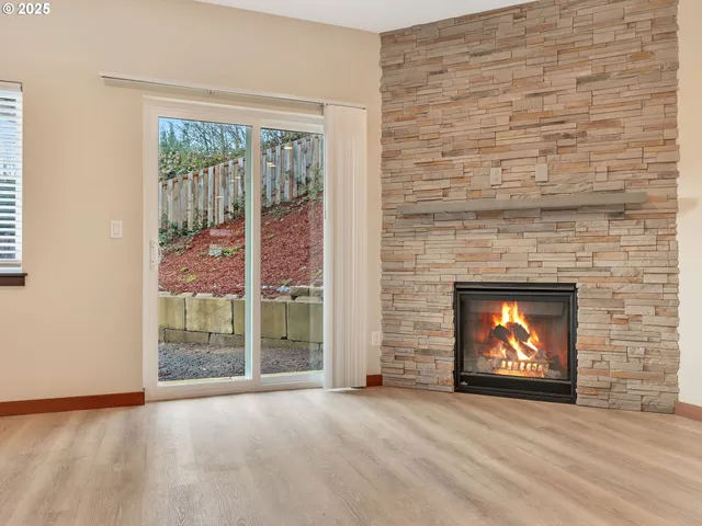 a view of an empty room with a fireplace