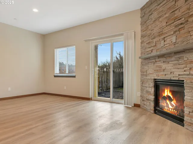 an empty room with a fireplace and window